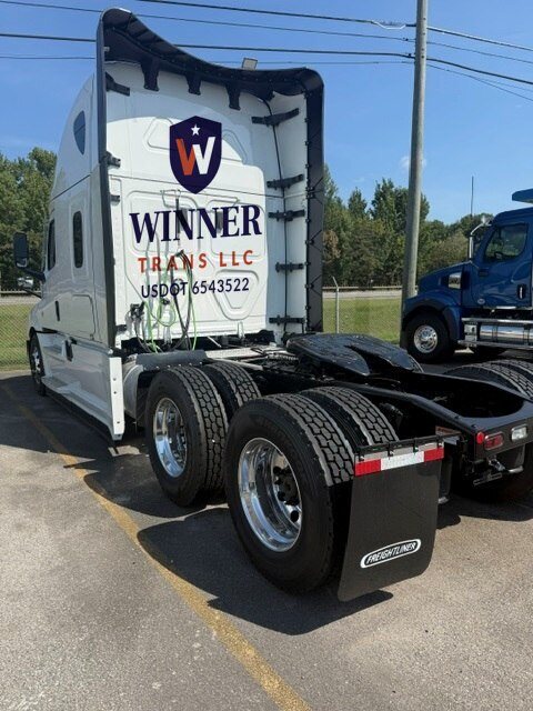 Rear of a Winner Trans LLC sleeper tractor with the company emblem