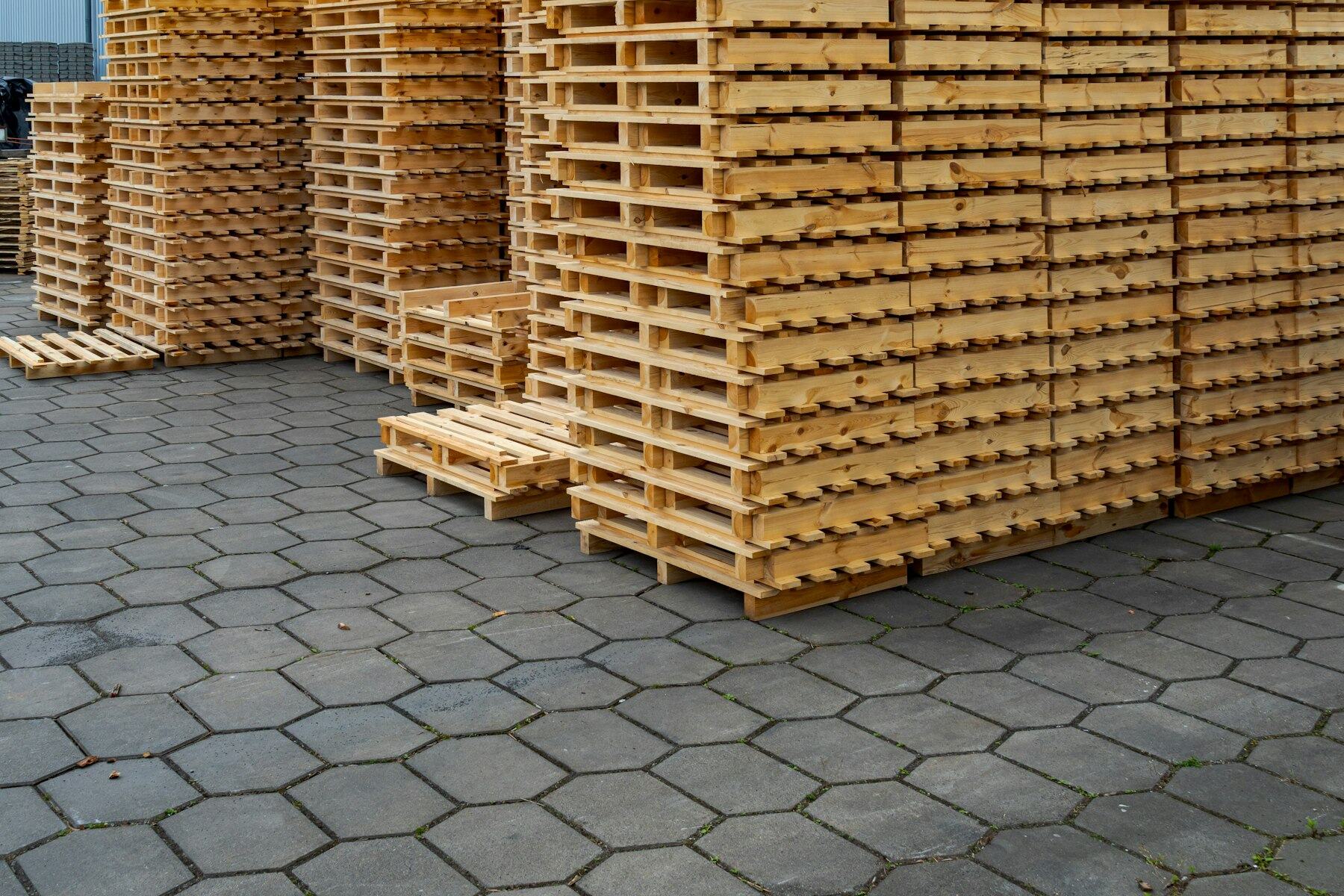 Stacks of wooden shipping pallets in a yard